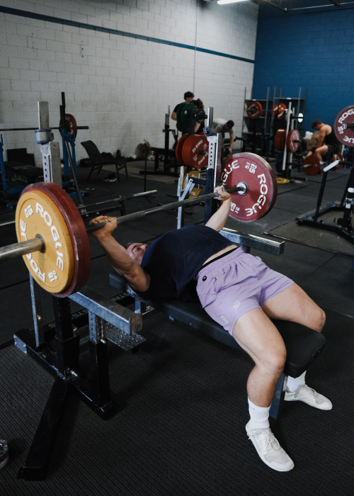 Male lifter bench pressing