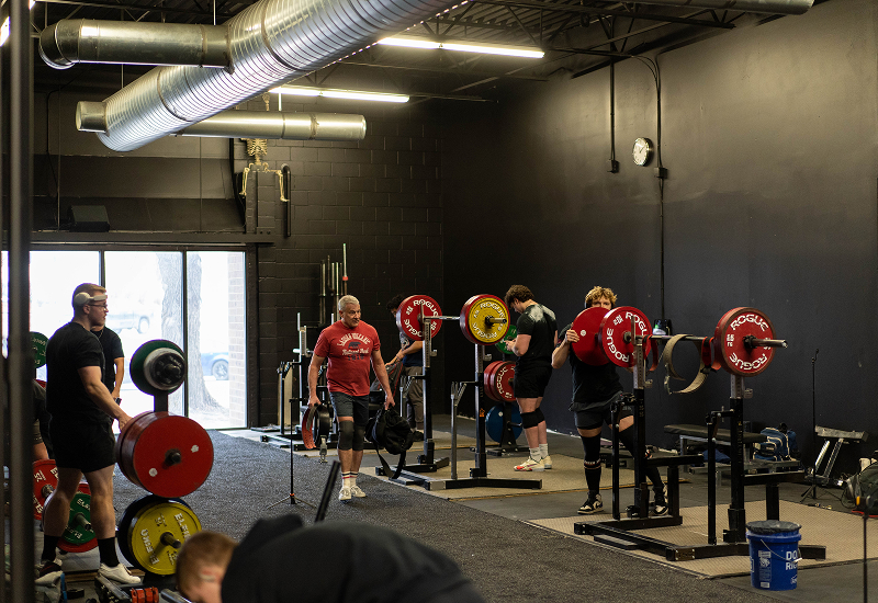 Powerlifters training with squat racks