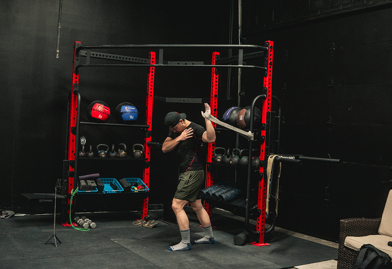 athlete warming up shoulder with bands